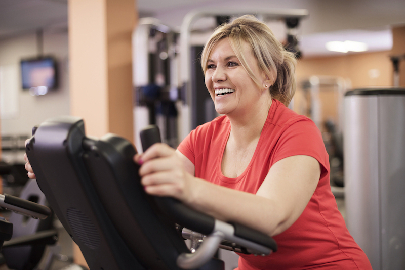 Woman running on a treadmill and smiling